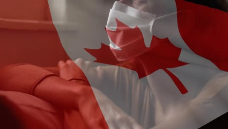 Animation-of-flag-of-canada-waving-over-woman-in-face-masks