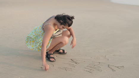 a young woman enjoys a peaceful day at the beach, playing with the soft sand