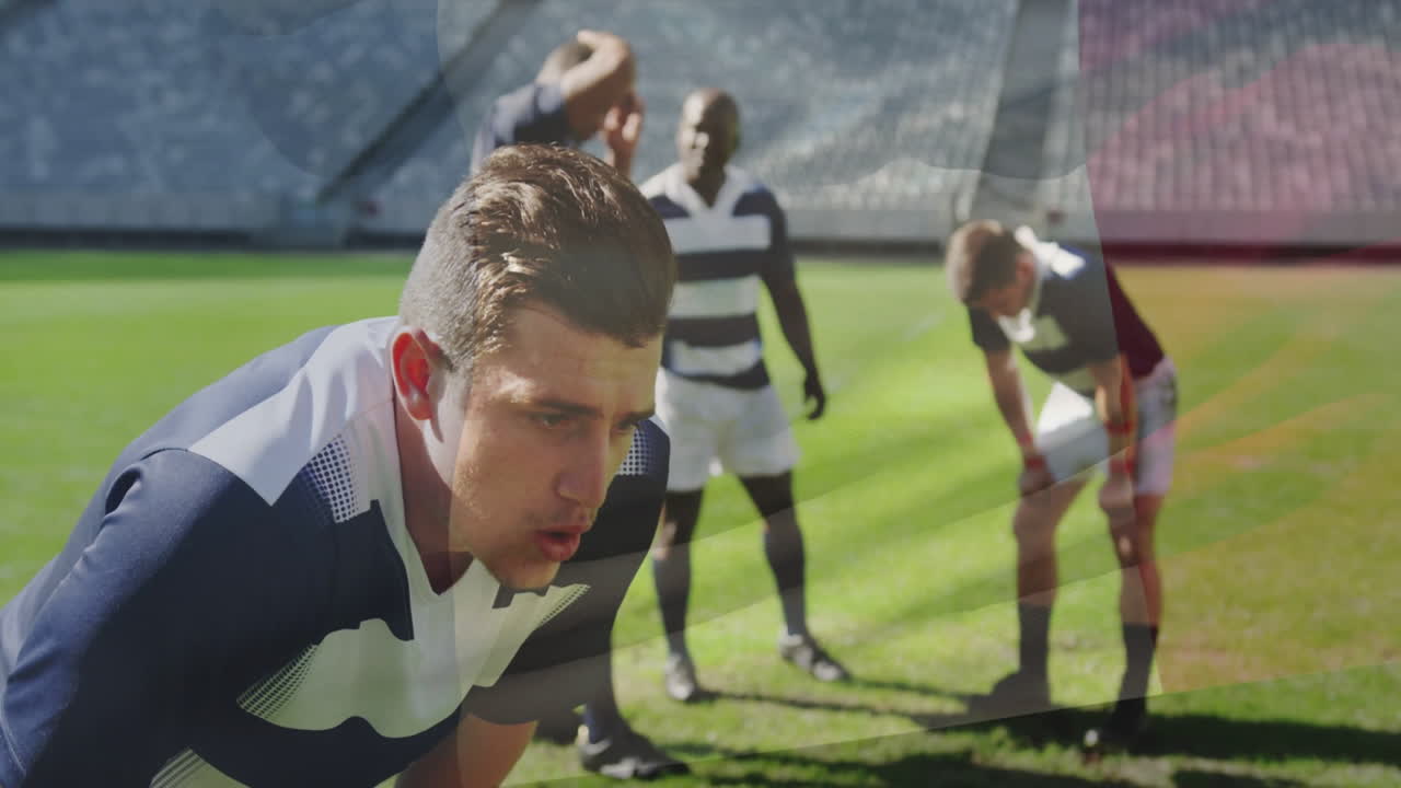 Rugby players resting on field in striped jerseys after intense match animation