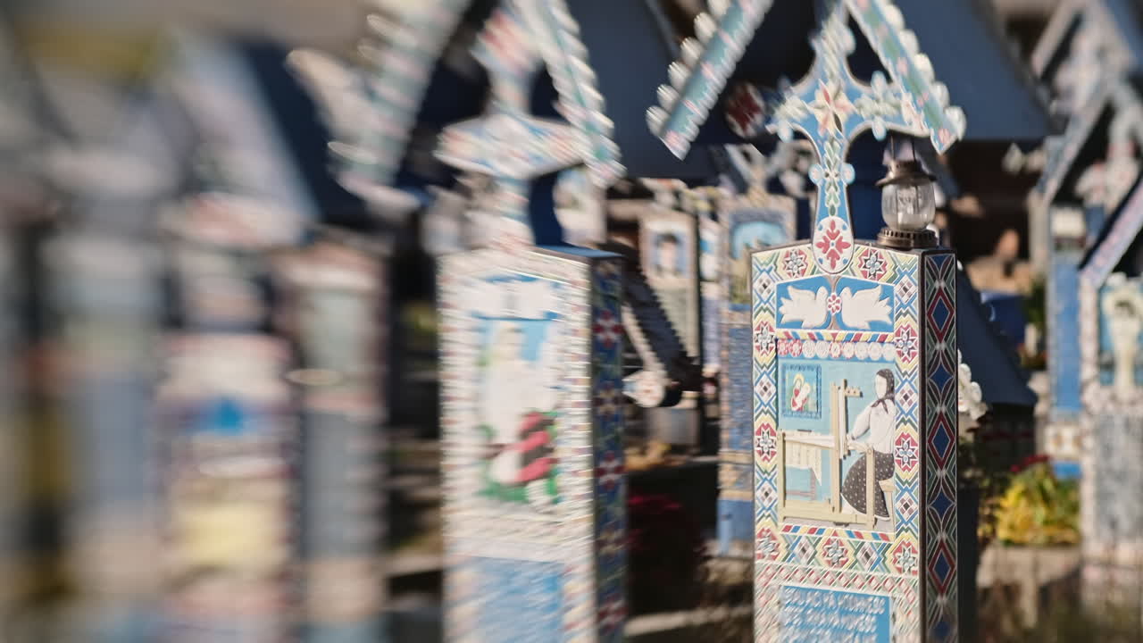 VISEU DE SUS, ROMANIA - OCTOBER 29, 2021: View of tombstones at the Merry Cemetery. Lensbaby effect