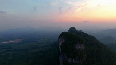 sunset hues paint the sky over surat thani, thailand. this aerial view captures breathtaking colors blending with serene landscapes, creating a tranquil and mesmerizing scene.