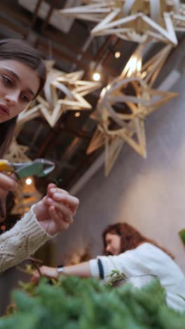 woman creating a floral arrangement