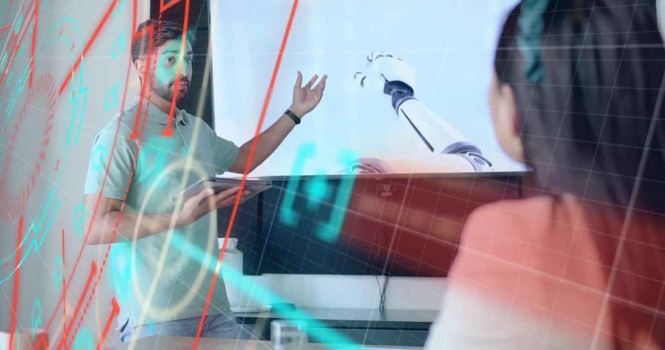 Presenter mengetuk tablet dan menjelaskan lengan robotik dengan overlay analitik untuk wawasan tim teknologi.