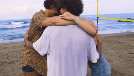 friends hugging on the beach.