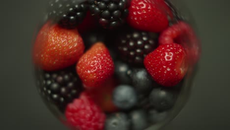 strawberries blackberries and blueberries in a cup rotating