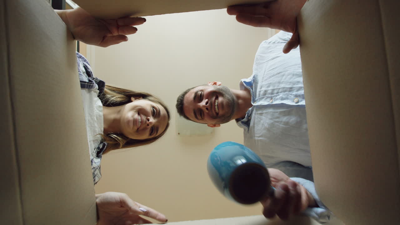 Couple Unpacking Moving Box
