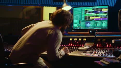 audio technician uses mixing and mastering techniques in studio