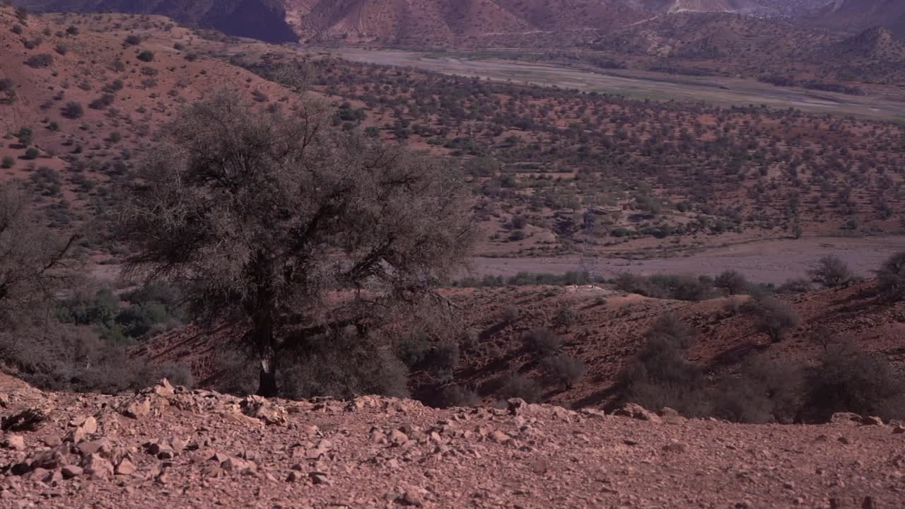 Panoramic View of High Voltage Electric Tower Amidst Morocco's Mountains, Pan from Left to Right