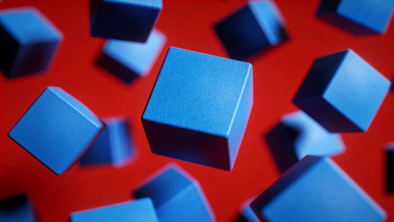 Shifting camera nudging central matte blue cube rotating forward on red backdrop, revealing depth