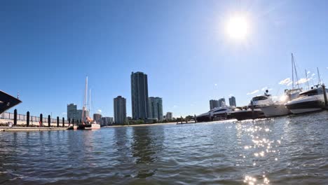 yachts docked under a bright sun