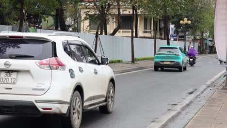 vehicles and motorbikes on a busy road