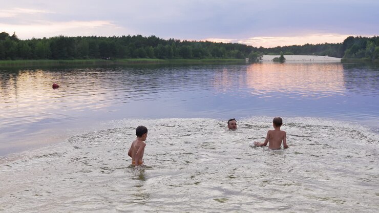 Father and sons going to the water on the beach