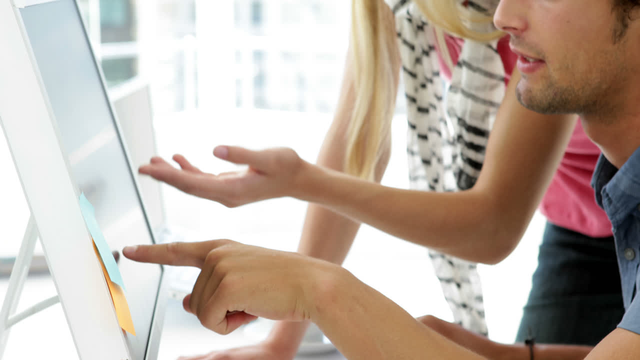 Blonde creative designer advising her colleague 