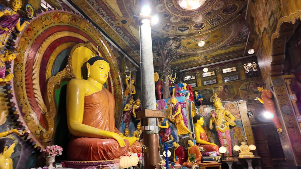 Sweeping view of beautiful religious statues inside a Buddhist Temple in Colombo, Sri Lanka