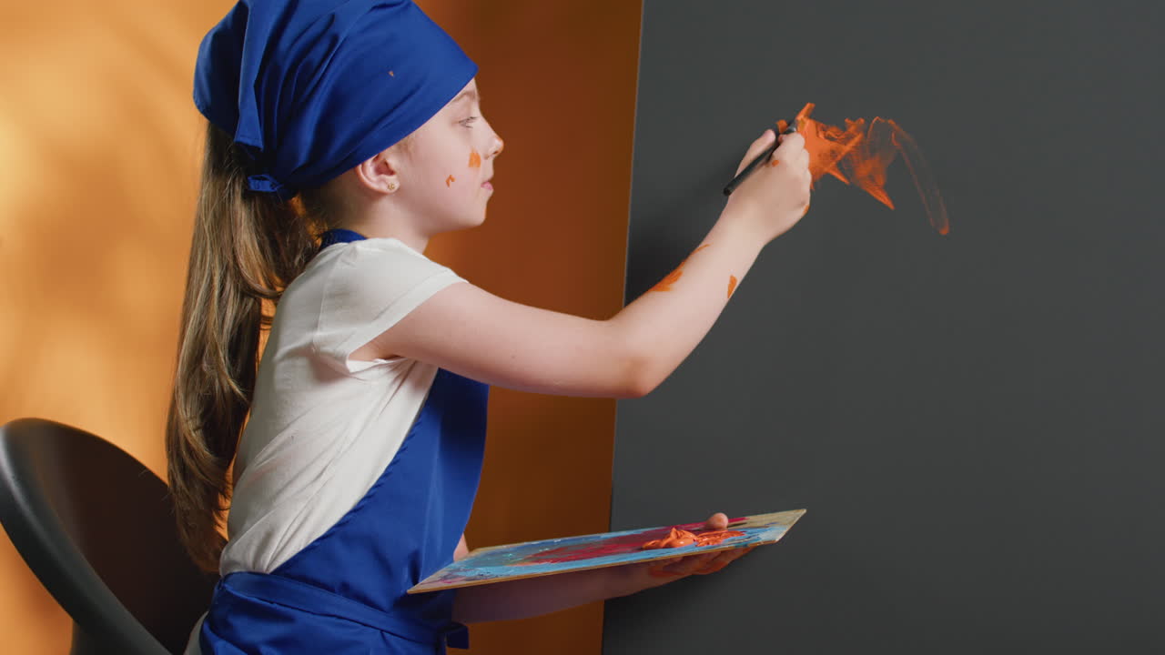 Girl painting on a canvas