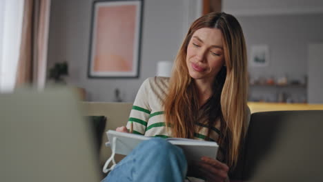 remote worker noting work tasks in copybook listening boss at conference closeup