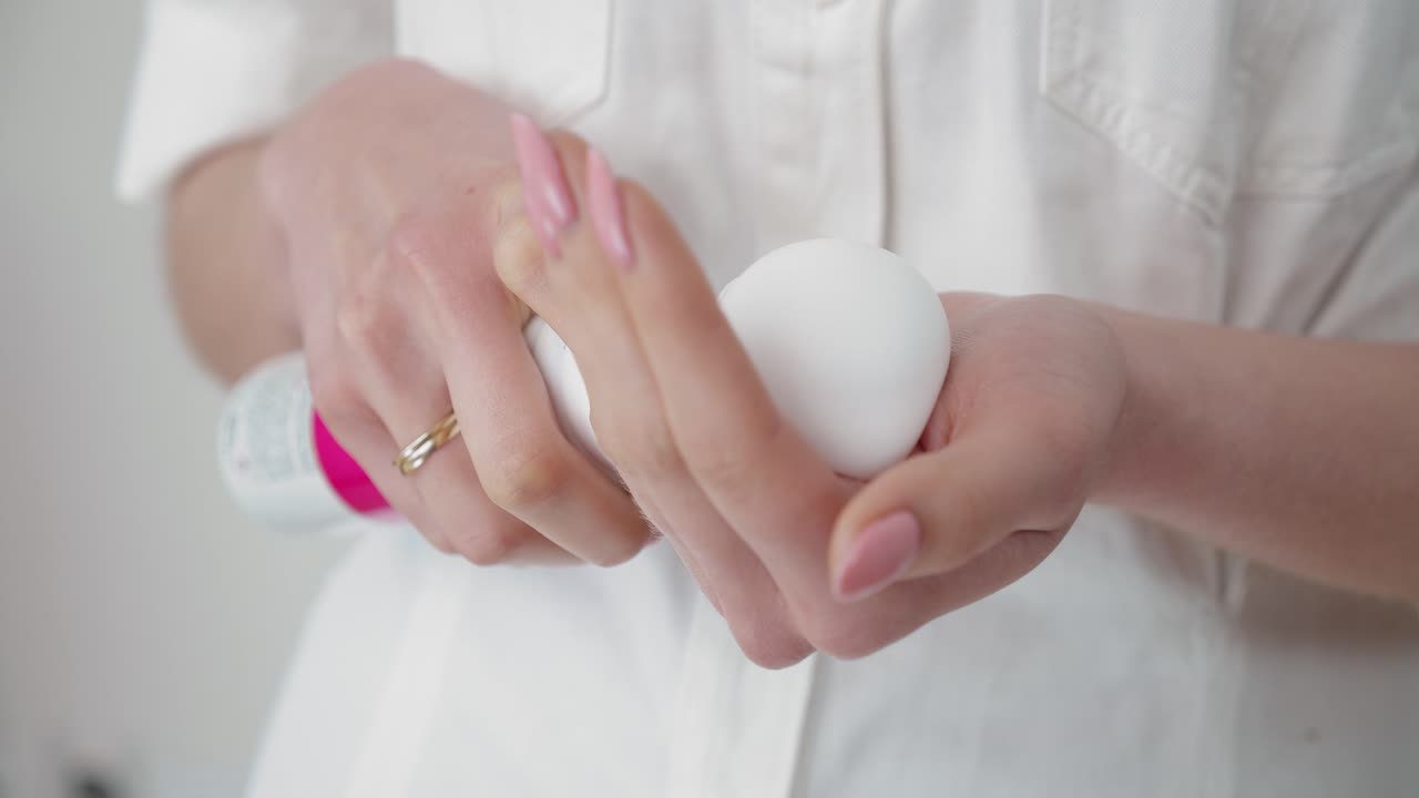 Skincare specialist preparing to add cleaning foam creme, close up view