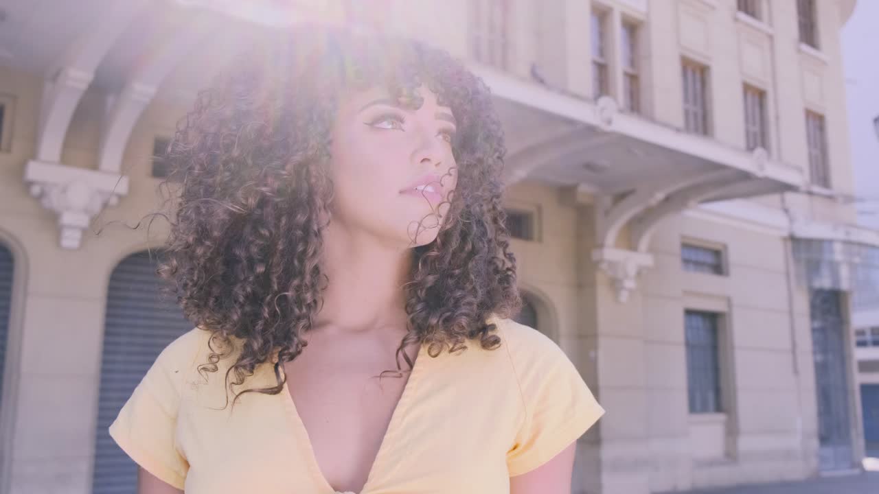 Woman with Curly Hair in Urban Setting