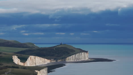 descending aerial shot from belle tout lighthouse revealing the seven sister chalk cliffs