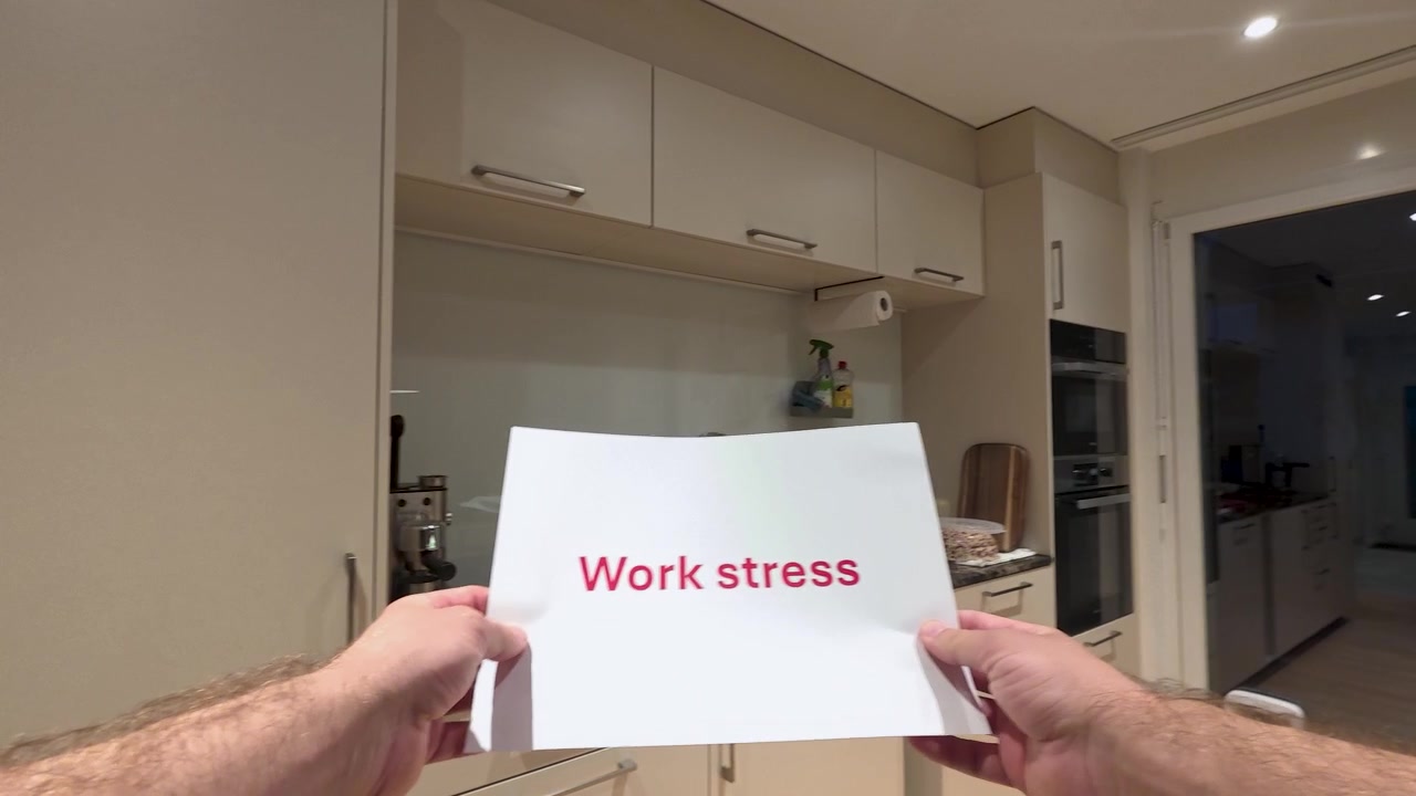 First-person POV holding a work stress sign at home. Ideal for workplace pressure, burnout, mental health, and stress awareness concepts.
