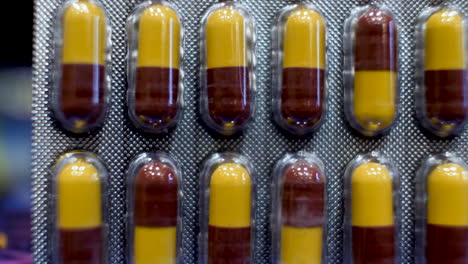 a close-up view of amoxicillin capsules as the dark red and yellow components are delicately arranged into their original packaging, encapsulates the essence of medical care and treatment