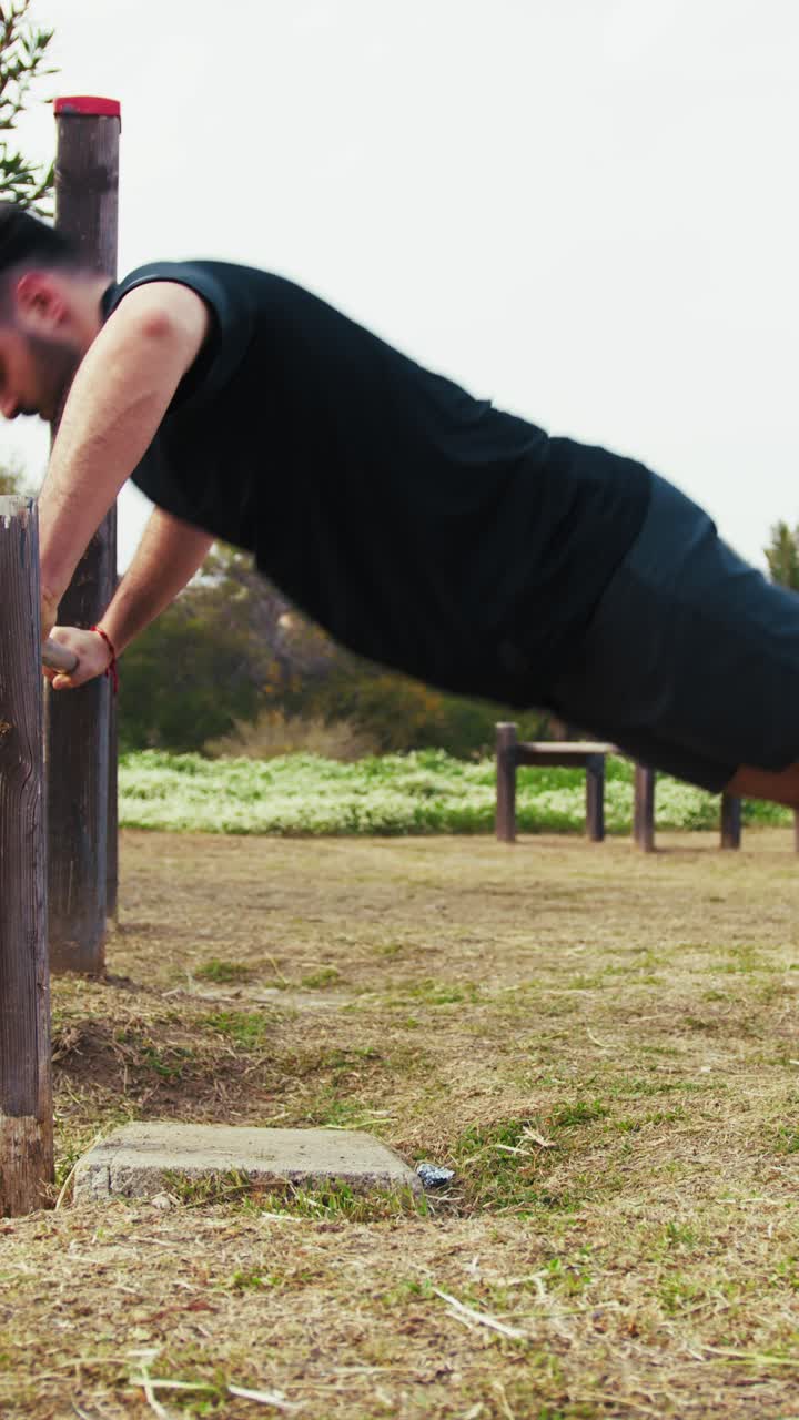 Man Does Push Ups Sport Exercise In The Park Using The Iron Bar