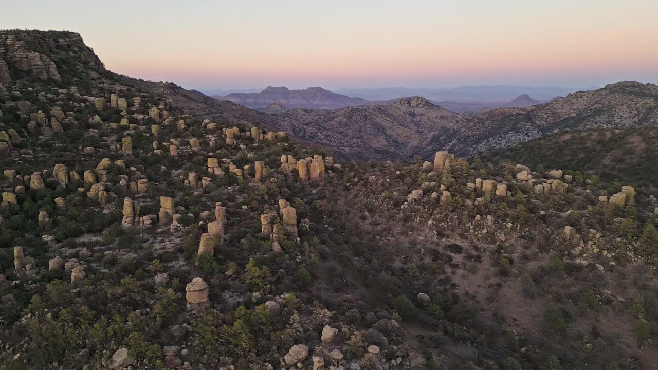 Rock formations in Chihuahua's Valle de los Monjes at dusk, peaceful and wide view