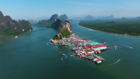 limestone island and floating village, koh panyee island in thailand - aerial drone shot