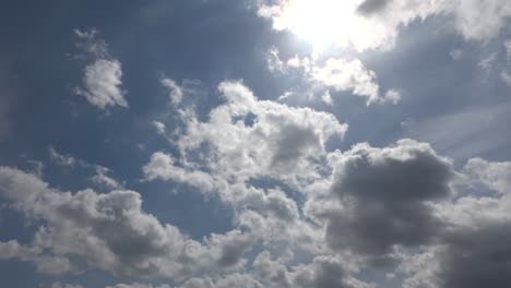 beautiful view at sunbeams with some lens flares and clouds in a blue sky