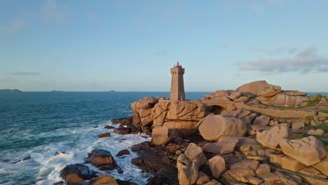 fly-over shot of phare du mean ruz lighthouse in bretagne france