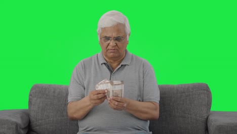 Indian-old-man-counting-money-Green-screen