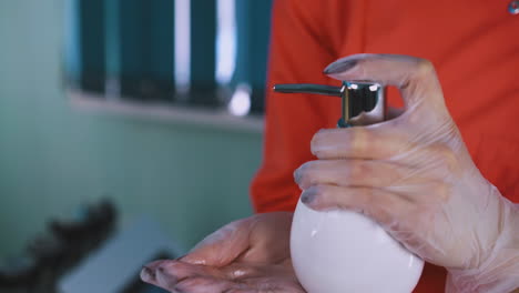 doctor-in-gloves-cleans-hands-with-antiseptic-closeup