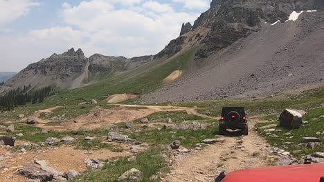 following 4wd vehicle moving along rocky portion of sidney basin loop trail in the yankee boy basin of the san juan mountains in colorado