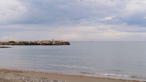 wide shot of the mediterranean sea in malaga spain with two boats in the background