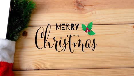 animation of merry christmas text and decorations on wooden background