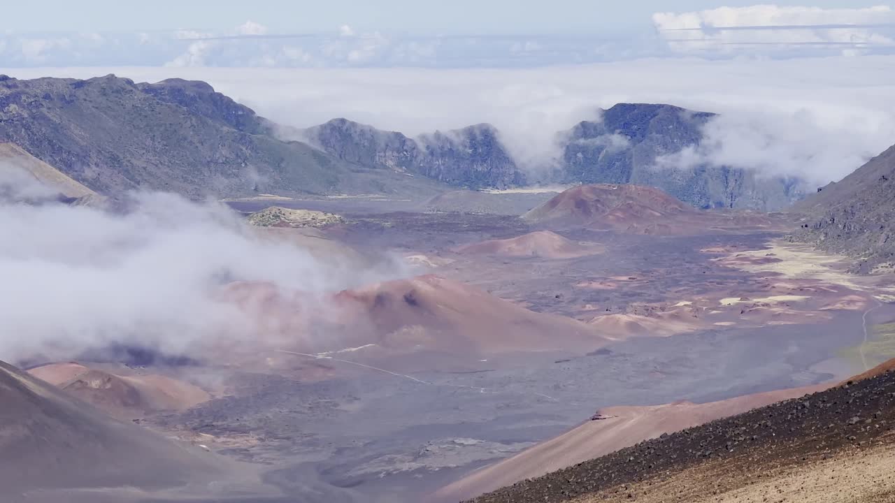 Cinematic booming up shot of the volcanic crater from the Sliding Sands trail at the summit of Haleakala on the island of Maui, Hawai'i