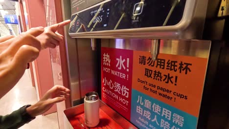 person using hot water machine in shanghai