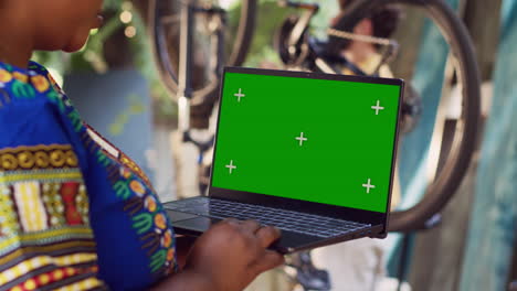 woman grasping laptop with greenscreen