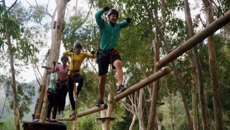 group of woman and trainer walking on the logs 4k