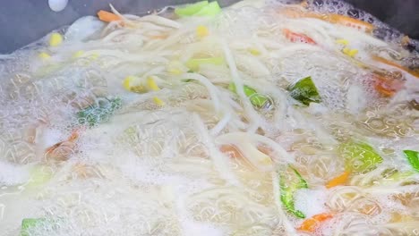 seafood kalguksu boiling in pot - korean knife cut noodle soup