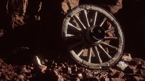 old-wooden-cart-wheel-on-stone-rocks