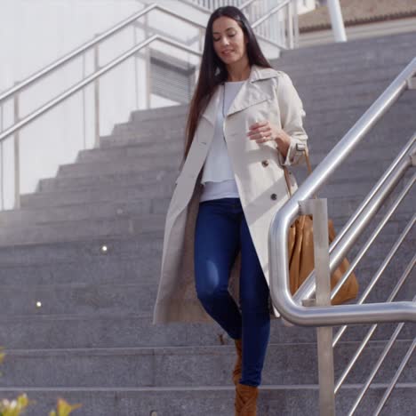 stylish woman walking down a flight of stairs