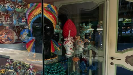 vibrant ceramic figures and plates in shop window