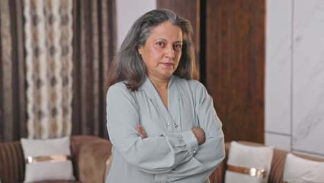 confident indian businesswoman standing crossed hands