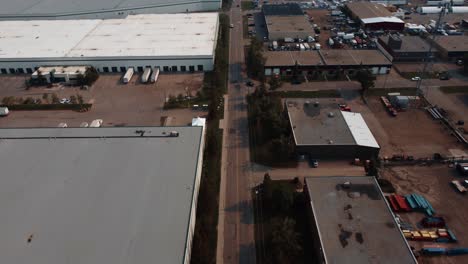 Revealing-drone-shot-of-the-long-road-in-an-industrial-area-in-Calgary,-Alberta