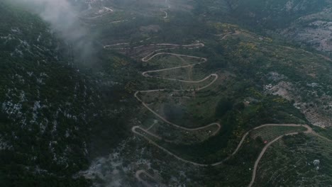 aerial drone shot of winding road by mountain in remote lebanon