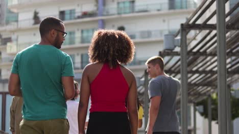 rear view of friends walking on street