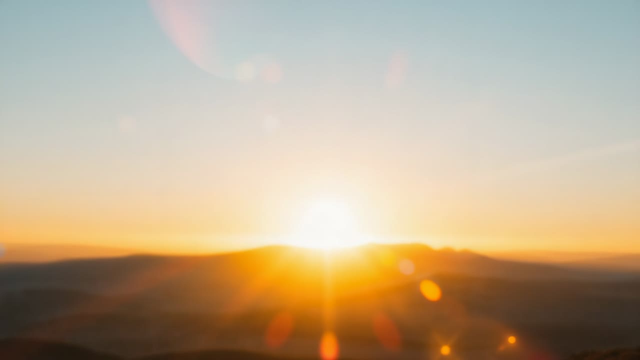 Emerging first light initiating rising sun climbing above hills ...