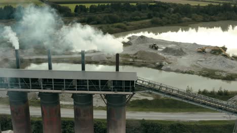 Flying through smoke with drone, coming from an industrial building