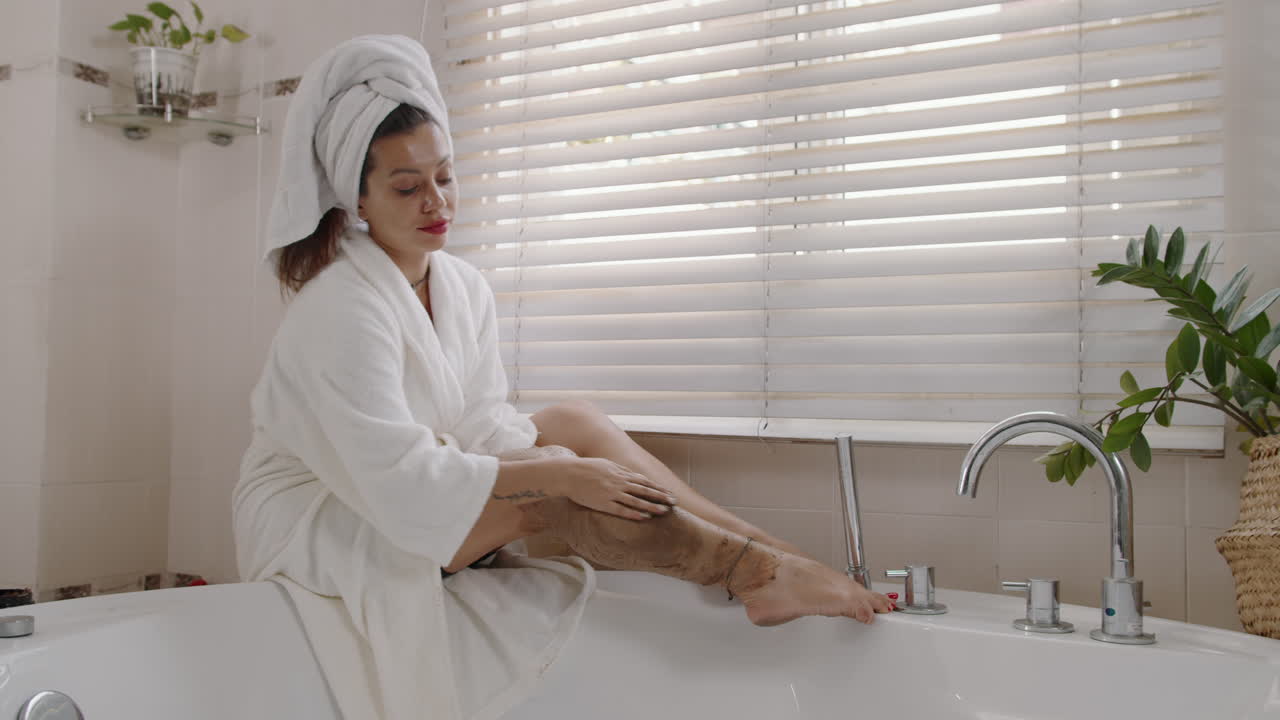 Caucasian Woman Applying Body Scrub on Legs